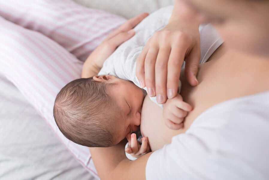 Mother breastfeeding baby